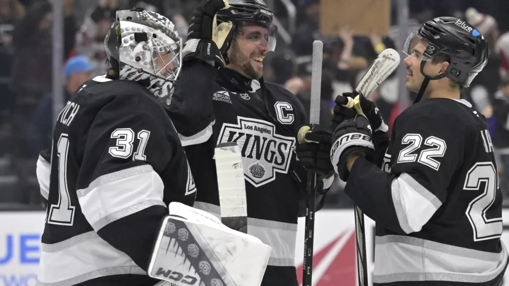 Nov 16, 2024; Los Angeles, California, USA; Los Angeles Kings goaltender David Rittich (31) is congratulated by center Anze Kopitar (11) and left wing Kevin Fiala (22) after defeating the Detroit Red Wings at Crypto.com Arena. Mandatory Credit: Jayne Kamin-Oncea-Imagn Images