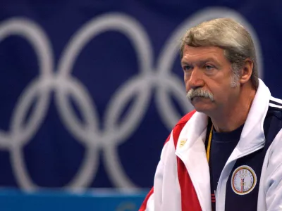 FILE PHOTO: Hungarian Bela Karolyi, coach of the U.S. gymnastics team, watches over training at the Sydney Superdome, September 14, 2000. REUTERS/Mike Blake/File Photo