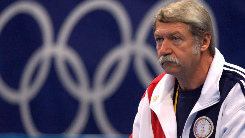 FILE PHOTO: Hungarian Bela Karolyi, coach of the U.S. gymnastics team, watches over training at the Sydney Superdome, September 14, 2000. REUTERS/Mike Blake/File Photo