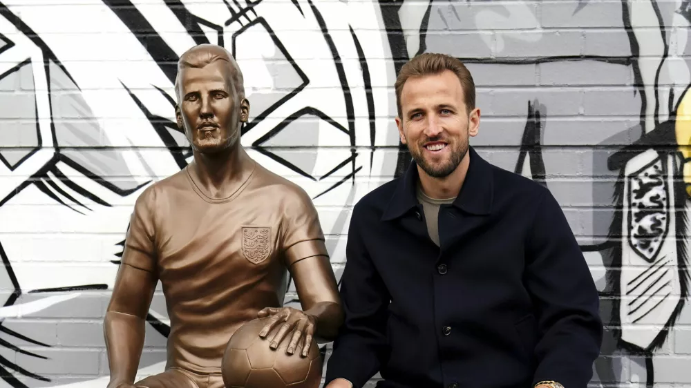 Harry Kane poses during the unveiling of a statue of himself at The Peter May Centre in London, Monday Nov. 18, 2024. (Zac Goodwin/PA via AP)