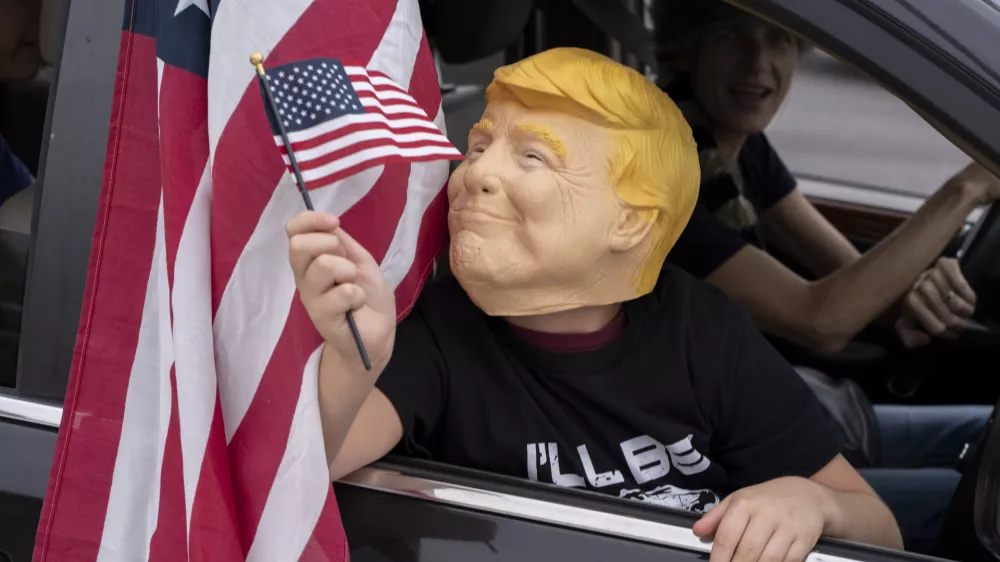 Supporters of President-elect Donald Trump participate in a victory parade, Sunday, Nov. 17, 2024, in West Palm Beach, Fla. (AP Photo/Alex Brandon)