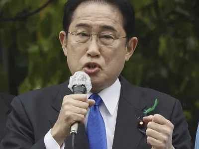 Japanese Prime Minister Fumio Kishida delivers a speech to support his ruling party's candidate in a local election, near a train station in Wakayama, western Japan Saturday, April 15, 2023. Kishida was evacuated unharmed after an explosion at a western port on Saturday, NHK television reported, and a suspect was apprehended for allegedly throwing the explosive. (Kyodo News via AP)