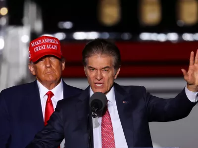 FILE PHOTO: Former U.S. President Donald Trump looks on as Pennsylvania Republican U.S. Senate candidate Dr. Mehmet Oz speaks at a pre-election rally to support Republican candidates in Latrobe, Pennsylvania, U.S., November 5, 2022. REUTERS/Mike Segar/File Photo