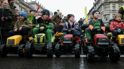 Children sit in toy tractors, as farmers protest against the Labour government's new agricultural policy, which includes a budget measure expected to increase inheritance tax liabilities for some farmers, in London, Britain, November 19, 2024. REUTERS/Mina Kim