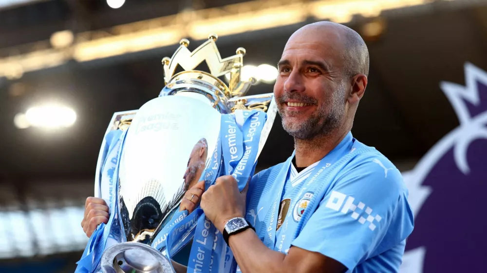 FILE PHOTO: Soccer Football - Premier League - Manchester City v West Ham United - Etihad Stadium, Manchester, Britain - May 19, 2024 Manchester City manager Pep Guardiola celebrates with the trophy after winning the Premier League Action Images via Reuters/Lee Smith EDITORIAL USE ONLY. NO USE WITH UNAUTHORIZED AUDIO, VIDEO, DATA, FIXTURE LISTS, CLUB/LEAGUE LOGOS OR 'LIVE' SERVICES. ONLINE IN-MATCH USE LIMITED TO 120 IMAGES, NO VIDEO EMULATION. NO USE IN BETTING, GAMES OR SINGLE CLUB/LEAGUE/PLAYER PUBLICATIONS. PLEASE CONTACT YOUR ACCOUNT REPRESENTATIVE FOR FURTHER DETAILS../File Photo