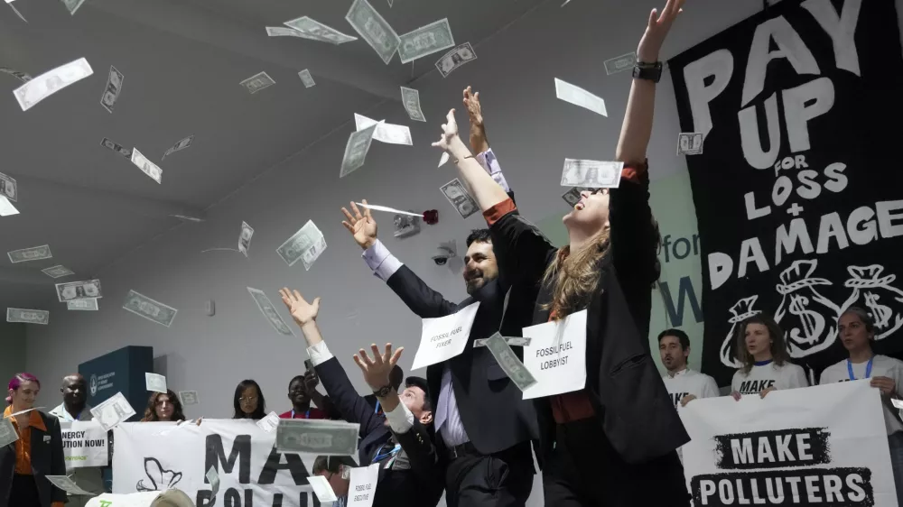 Activists participate in a demonstration for climate finance at the COP29 U.N. Climate Summit, Thursday, Nov. 21, 2024, in Baku, Azerbaijan. (AP Photo/Sergei Grits)