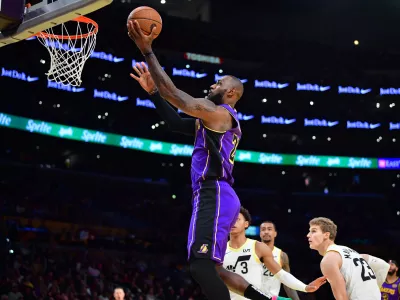 Nov 19, 2024; Los Angeles, California, USA; Los Angeles Lakers forward LeBron James (23) scores a basket against the against the Utah Jazz during the first half at Crypto.com Arena. Mandatory Credit: Gary A. Vasquez-Imagn Images