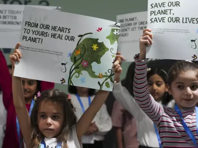 Children advocate for a clean planet during the COP29 U.N. Climate Summit, Thursday, Nov. 21, 2024, in Baku, Azerbaijan. (AP Photo/Peter Dejong)