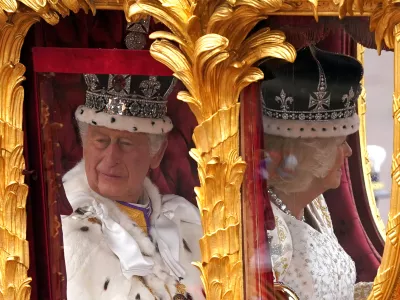 06 May 2023, United Kingdom, London: King Charles III (L) and Queen Camilla are carried in the Gold State Coach, pulled by eight Windsor Greys, in The Coronation Procession as they return along The Mall to Buckingham Palace, London, following their coronation ceremony. Photo: Niall Carson/PA Wire/dpa