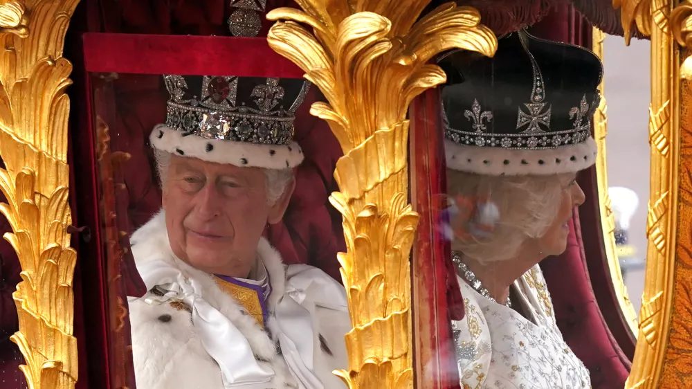 06 May 2023, United Kingdom, London: King Charles III (L) and Queen Camilla are carried in the Gold State Coach, pulled by eight Windsor Greys, in The Coronation Procession as they return along The Mall to Buckingham Palace, London, following their coronation ceremony. Photo: Niall Carson/PA Wire/dpa