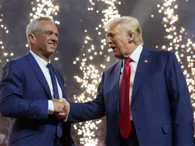 Republican presidential nominee former President Donald Trump shakes hands with Independent presidential candidate Robert F. Kennedy Jr. at a campaign rally at the Desert Diamond Arena, Friday, Aug. 23, 2024, in Glendale, Ariz. (AP Photo/Evan Vucci)