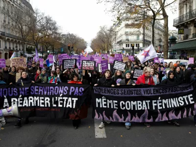 People attend a demonstration to protest against femicide, sexual violence and all gender-based violence to mark the International Day for Elimination of Violence Against Women, in Paris, France, November 23, 2024. The banners read: "We won't serve the rearming of the state" and "Sexist violences, fascist violences, same feminist fight". REUTERS/Abdul Saboor