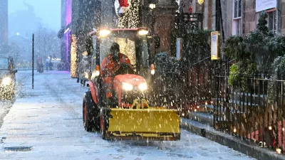 A snow plough clears the snow during Storm Bert, along George Street in Edinburgh, Scotland, Britain, November 23, 2024. REUTERS/Lesley Martin