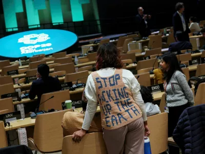 An activist stands during a closing plenary meeting at the COP29 United Nations Climate Change Conference, in Baku, Azerbaijan November 24, 2024. REUTERS/Murad Sezer   TPX IMAGES OF THE DAY