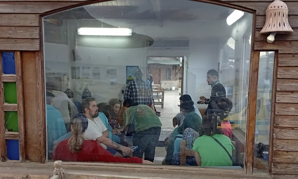 Survivors rest at a coffee shop in Marsa Alam, Egypt, Monday, Nov. 25, 2024 after a tourist yacht sank in the Red Sea following warnings about rough seas. (AP Photo)