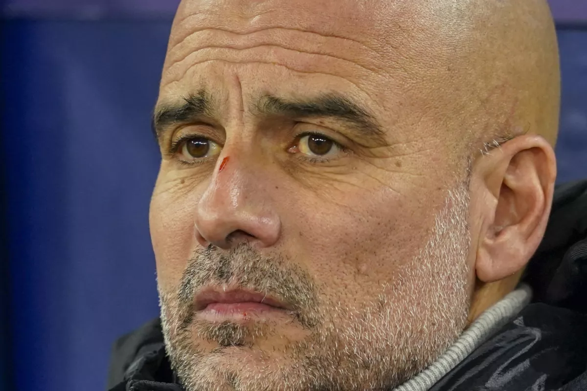 Manchester City's head coach Pep Guardiola takes his seat on the bench before the Champions League opening phase soccer match between Manchester City and Feyenoord at the Etihad Stadium in Manchester, England, Tuesday, Nov. 26, 2024. (AP Photo/Dave Thompson)