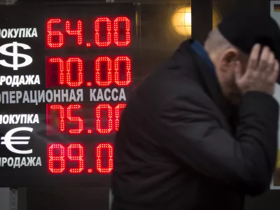 ﻿Signs advertising currencies light next to the exchange office in Moscow, Russia, Tuesday, Dec. 16, 2014. After a massive overnight rate hike by Russia's Central Bank, the ruble staged a two-hour rally Tuesday morning before rolling back to new historic lows. The surprise Central Bank decision to raise the rate to 17 percent from 10.5 percent came in the early hours on Tuesday in a desperate attempt to prop up the troubled currency. It's the biggest interest rate hike since 1998, the year when Russia defaulted on its sovereign bonds.(AP Photo / Alexander Zemlianichenko)