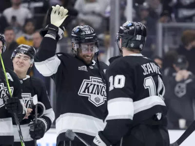 Los Angeles Kings center Anze Kopitar, left, celebrates with left wing Tanner Jeannot after the team's win against the Winnipeg Jets in an NHL hockey game Wednesday, Nov. 27, 2024, in Los Angeles. (AP Photo/Ryan Sun)