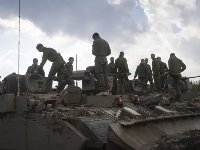 Israeli soldiers stand atop army armoured vehicles outside the agricultural settlement of Avivim, next to the Lebanese border in upper Galilee, Israel, Thursday Nov 28, 2024. (AP Photo/Ohad Zwigenberg)