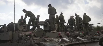 Israeli soldiers stand atop army armoured vehicles outside the agricultural settlement of Avivim, next to the Lebanese border in upper Galilee, Israel, Thursday Nov 28, 2024. (AP Photo/Ohad Zwigenberg)