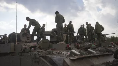 Israeli soldiers stand atop army armoured vehicles outside the agricultural settlement of Avivim, next to the Lebanese border in upper Galilee, Israel, Thursday Nov 28, 2024. (AP Photo/Ohad Zwigenberg)