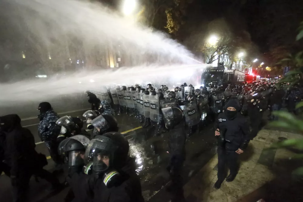 Police use a water cannon to prevent protesters pouring into the streets following Georgian Prime Minister Irakli Kobakhidze's announcement, rallying outside the parliament building in Tbilisi, Georgia, on Friday, Nov. 29, 2024. (AP Photo/Zurab Tsertsvadze)