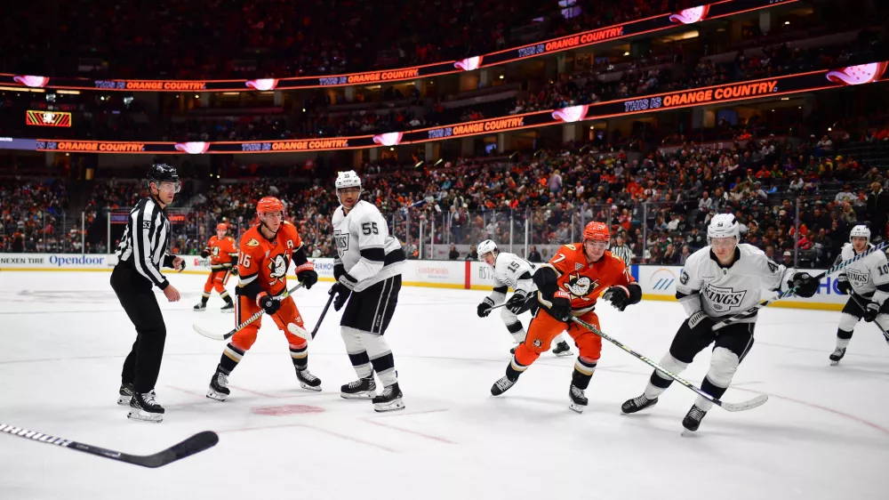 Nov 29, 2024; Anaheim, California, USA; Anaheim Ducks right wing Frank Vatrano (77) plays for the puck against Los Angeles Kings defenseman Jacob Moverare (43) during the second period at Honda Center. Mandatory Credit: Gary A. Vasquez-Imagn Images