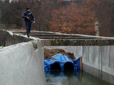 A police officer patrols near the damaged canal in northern Kosovo supplying water to two coal-fired power plants that generate nearly all of the country's electricity, in Varage, near Zubin Potok, Kosovo November 30, 2024. REUTERS/Valdrin Xhemaj