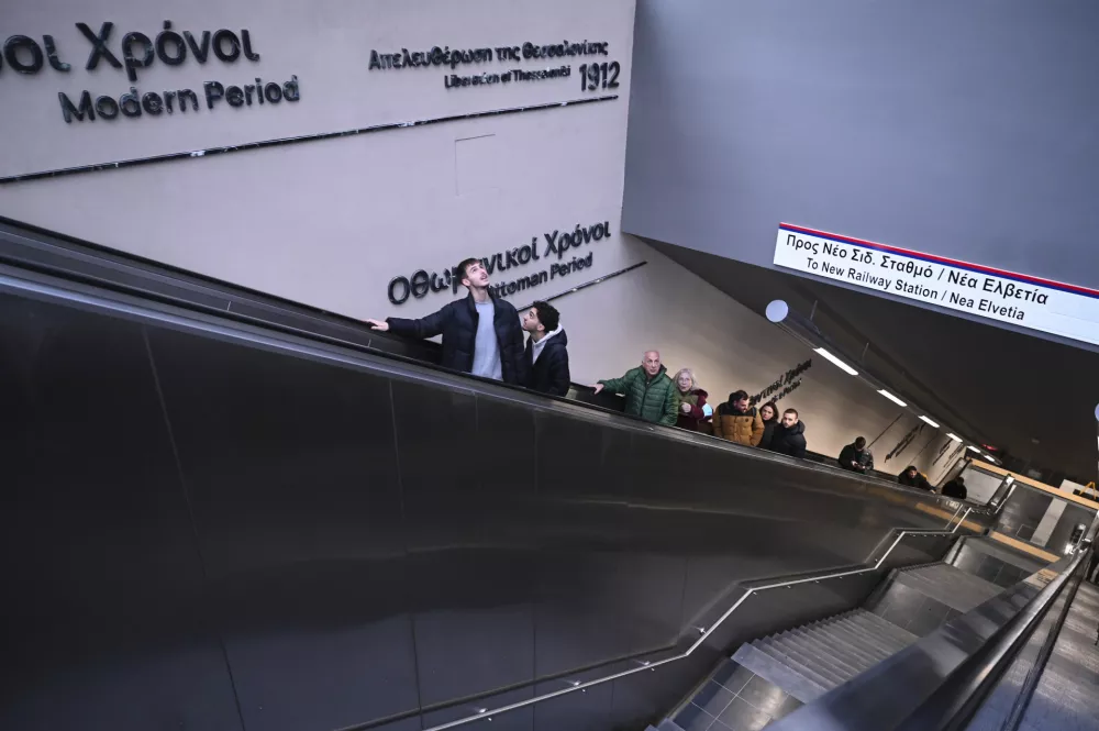 Commuters use the ecalator at a metro station during the inauguration day of the Thessaloniki metro, in Thessaloniki, northern Greece, Saturday, Nov. 30, 2024. (AP Photo/Giannis Papanikos)