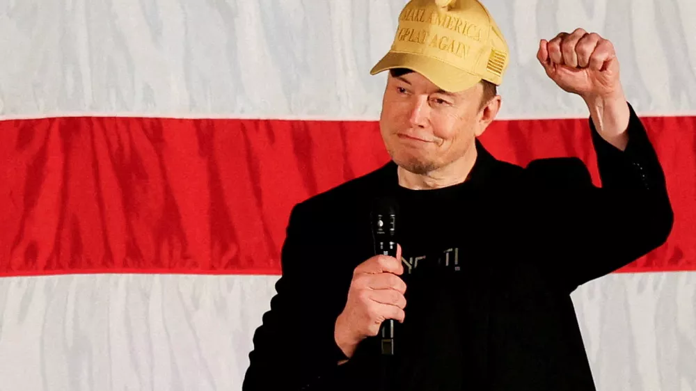 FILE PHOTO: Tesla CEO and X owner Elon Musk, who supports Republican presidential nominee former U.S. President Donald Trump, gestures as he speaks about voting during an America PAC Town Hall in Folsom, Pennsylvania, U.S., October 17, 2024. REUTERS/Rachel Wisniewski/File Photo