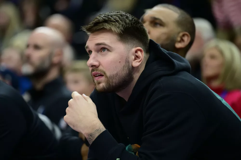 Dallas Mavericks guard Luka Doncic watches from the bench during the second half of an NBA basketball game Saturday, Nov. 30, 2024, in Salt Lake City. (AP Photo/Tyler Tate)