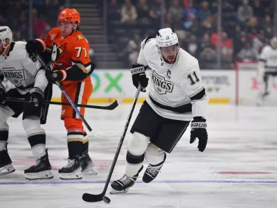 Nov 29, 2024; Anaheim, California, USA; Los Angeles Kings center Anze Kopitar (11) moves the puck against the Anaheim Ducks during the first period at Honda Center. Mandatory Credit: Gary A. Vasquez-Imagn Images