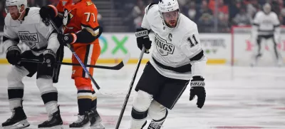 Nov 29, 2024; Anaheim, California, USA; Los Angeles Kings center Anze Kopitar (11) moves the puck against the Anaheim Ducks during the first period at Honda Center. Mandatory Credit: Gary A. Vasquez-Imagn Images