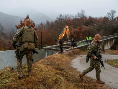 Latvia's soldiers, part of the NATO-led peacekeeping force KFOR, patrol near the damaged canal in northern Kosovo, supplying water to two coal-fired power plants that generate nearly all of the country's electricity, in Varage, near Zubin Potok, Kosovo November 30, 2024. REUTERS/Valdrin Xhemaj