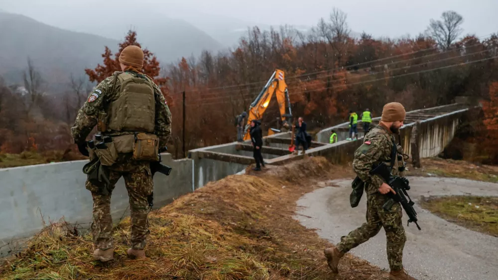 Latvia's soldiers, part of the NATO-led peacekeeping force KFOR, patrol near the damaged canal in northern Kosovo, supplying water to two coal-fired power plants that generate nearly all of the country's electricity, in Varage, near Zubin Potok, Kosovo November 30, 2024. REUTERS/Valdrin Xhemaj