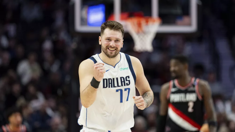 Dallas Mavericks guard Luka Doncic reacts to his teammate's made shot against the Portland Trail Blazers during the second half of an NBA basketball game Sunday, Dec. 1, 2024, in Portland, Ore. (AP Photo/Howard Lao)