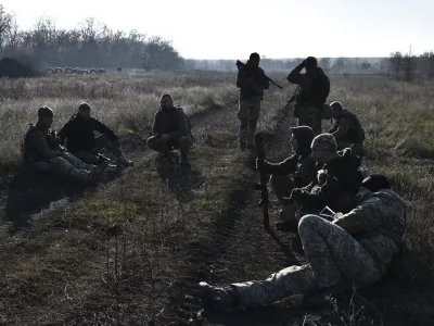 In this photo provided by the Ukraine's 65th Mechanised Brigade press service on Nov. 19, 2024, Ukrainian soldiers rest during a training at a polygon in Zaporizhzhia region, Ukraine. (Andriy Andriyenko/Ukraine's 65th Mechanised Brigade via AP)