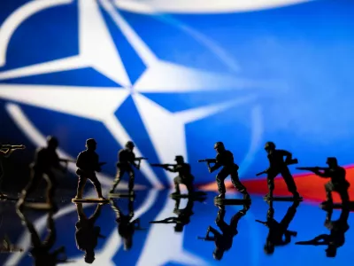 FILE PHOTO: Army soldier figurines are displayed in front of the NATO logo and Russian flag colours background in this illustration taken, February 13, 2022. REUTERS/Dado Ruvic/Illustration/File Photo