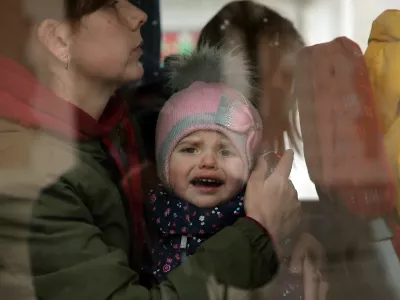 A Ukrainian refugees child reacts as he boards a bus after arriving at Hendaye train station, southwestern France, Wednesday, March 9, 2022. About 200 Ukrainian refugees are arriving in the French Atlantic coast town of Hendaye, where local authorities are greeting them in the train station and offering them temporary lodging. They are among 2 million people, mostly women and children, who have fled fighting in Ukraine since Russia's invasion two weeks ago and are seeking refuge around Europe.(AP Photo/Bob Edme)