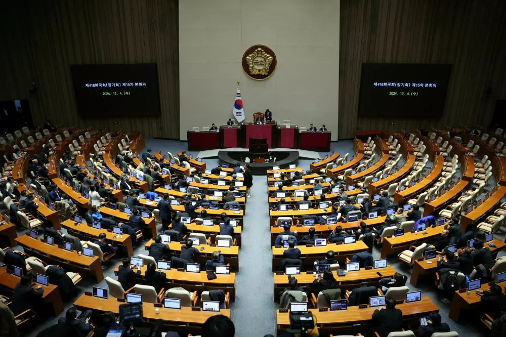 Lawmakers sit inside the hall at the National Assembly, after South Korean President Yoon Suk Yeol declared martial law, in Seoul, South Korea, December 4, 2024. REUTERS/Kim Hong-Ji