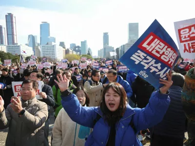 People hold placards that read "Step down President Yoon Suk Yeol" and "Investigate his act of rebellion immediately", at a rally to condemn South Korean President's surprise declarations of the martial law last night and to call for his resignation, at the national assembly in Seoul, South Korea, December 4, 2024. REUTERS/Kim Hong-Ji