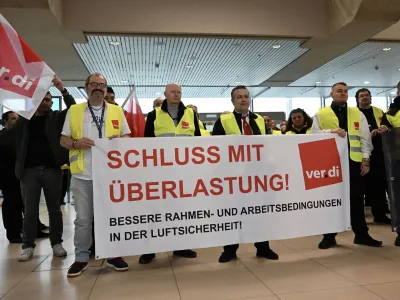 Aviation security workers of Germany's Verdi union gather at Cologne-Bonn airport during a strike in Cologne, Germany, April 20, 2023. The placard reads "end pressure of work". REUTERS/Jana Rodenbusch