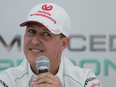 FILE - Michael Schumacher announces his retirement from Formula One during a press conference at the Suzuka Circuit venue for the Japanese Formula One Grand Prix in Suzuka, Japan, Oct. 4, 2012. The family of Formula One great Michael Schumacher plans to take legal action against a German magazine for publishing what it claimed to be an artificial intelligence-generated interview with Schumacher. Family spokesperson Sabine Kehm confirmed to The Associated Press by email on Thursday, April 20, 2023, that legal action is being planned over a "fake artificial intelligence interview by German outlet Die Aktuelle." (AP Photo/Itsuo Inouye, file)