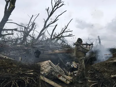 A Ukrainian soldier fires an RPG toward Russian positions at the frontline near Avdiivka, an eastern city where fierce battles against Russian forces have been taking place, in the Donetsk region, Ukraine, Friday, April 28, 2023. (AP Photo/Libkos)