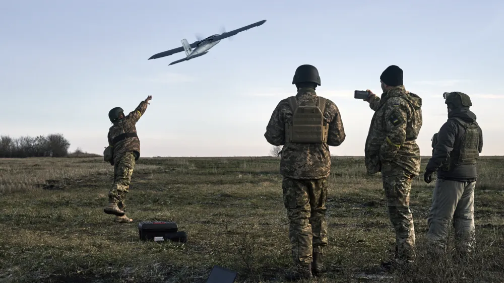 Ukrainian soldiers launch a drone at Russian positions near Bakhmut, Donetsk region, Ukraine, Thursday, Dec. 15, 2022. (AP Photo/LIBKOS)