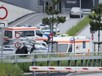 Police emergency vehicles are parked at a Mercedes-Benz plant in Sindelfingen, Germany, Thursday May 11, 2023.. A man opened fire at a Mercedes-Benz factory in southwestern Germany on Thursday, leaving one person dead and another person seriously wounded, German prosecutors confirmed. (Julian Rettig/dpa via AP)