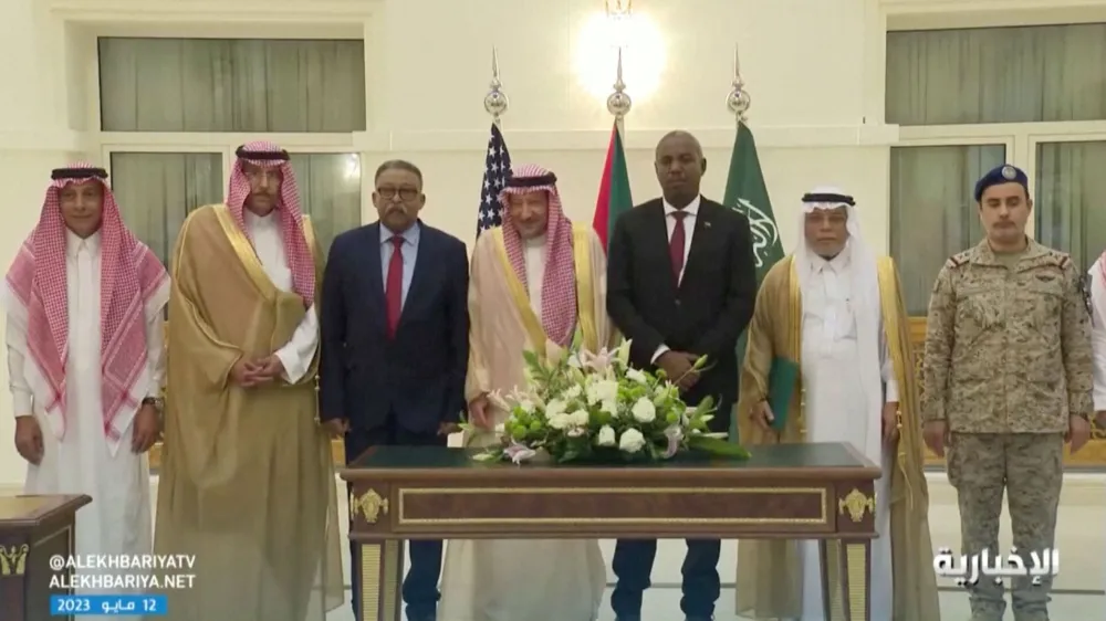 Officials stand for pictures after Sudan's army and rival paramilitary rapid support force signed a declaration, that signifies their commitment to protect the civilians of Sudan but not to a ceasefire, in Jeddah, Saudi Arabia, May 11, 2023. Al Ekhbariya/Handout via REUTERS  THIS IMAGE HAS BEEN SUPPLIED BY A THIRD PARTY. NO RESALES. NO ARCHIVES. MUST NOT OBSCURE LOGO.