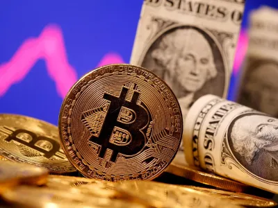 FILE PHOTO: A representation of virtual currency Bitcoin and U.S. One Dollar banknotes are seen in front of a stock graph in this illustration taken January 8, 2021. REUTERS/Dado Ruvic/File Photo