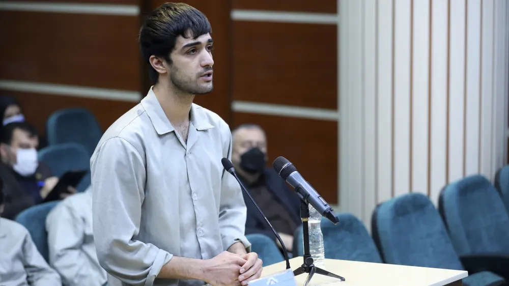 In this photo released by Mizan News Agency, Mohammad Mehdi Karami, a protester convicted and executed, speaks during his trial at the Revolutionary Court, in the city of Karaj, Iran, on Nov. 30, 2022. Iran said it executed Karami and Mohammad Hosseini on Saturday, Jan. 7, 2023, convicted of allegedly killing a paramilitary volunteer during a demonstration, the latest executions aimed at halting the nationwide protests now challenging the country's theocracy. (Amir Abbas Ghasemi/Mizan News Agency via AP)