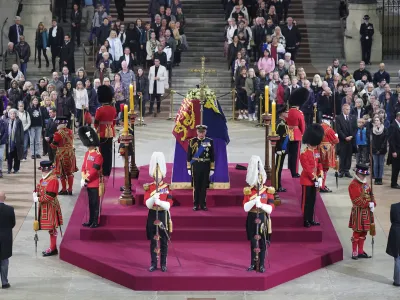 FILE - Members of the public file past as King Charles III, Princess Anne, Prince Andrew and Prince Edward hold a vigil beside the coffin of their mother, Queen Elizabeth II, as it lies in state on the catafalque in Westminster Hall, at the Palace of Westminster, London, Sept. 16, 2022. Queen Elizabeth II's funeral and lying-in-state last year cost Britain's government an estimated 162 million pounds (around 0 million), the treasury said Thursday May 18, 2023. (Yui Mok/Pool Photo via AP, File)